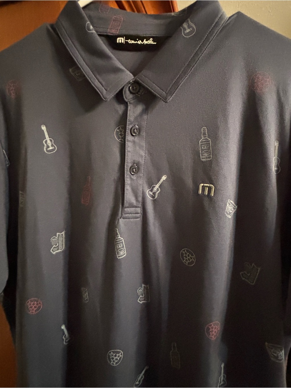 Travis Mathew Navy Polo with Multicolor Micro Icon Print
